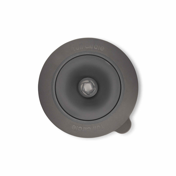 Top view of a round, grey silicone lid features a central knob and side tab. Full Circle is embossed on the outer edge, highlighting eco-friendly materials like those in their Sinksational Sink Strainer.