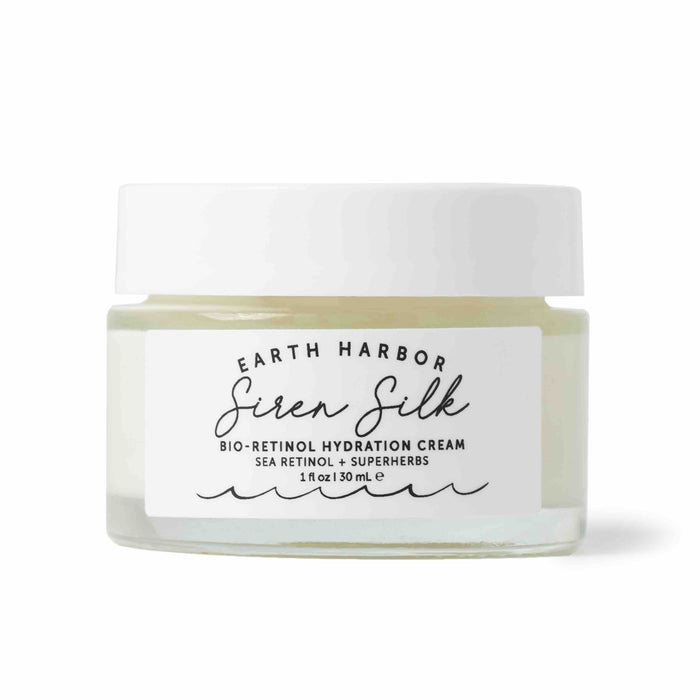 Earth Harbors SIREN SILK Bio-Retinol Hydration Cream features a clear jar with a white lid, revealing its light cream contents. This 1 fl oz / 30 mL treatment integrates Sea Retinol + Superherbs for anti-aging effects.