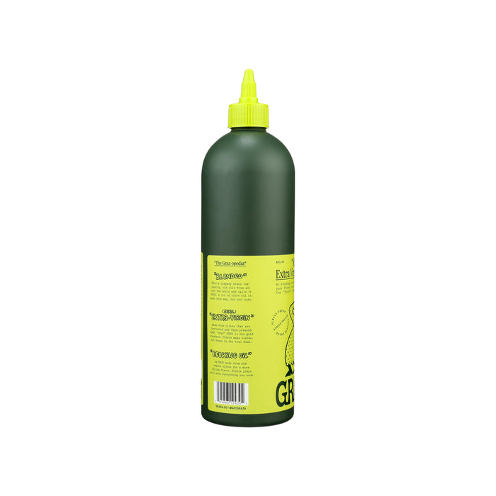 A green plastic bottle of Sizzle Extra Virgin Olive Oil - For Cooking by Graza features a yellow label with tree art, symbolizing mature olives. It has a pointed nozzle cap and stands upright on a pristine white background.