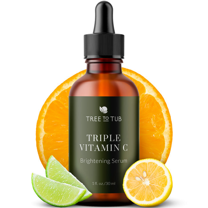 A brown dropper bottle labeled Skin Brightening Triple Action Vitamin C Serum for Face from Tree To Tub stands prominently with a sliced orange, plus lime and lemon slices below. This 1 fl oz/30 ml serum offers brightening and anti-aging benefits for your skin.