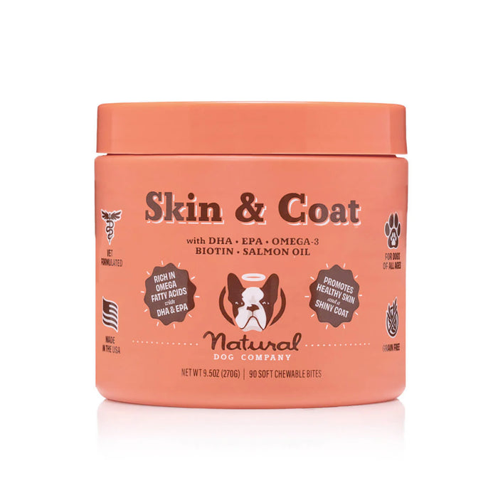 The Skin & Coat Supplement for Dogs by Natural Dog Company, in an orange container with a dog graphic, offers 90 soft chews with DHA, EPA, Omega-3, Biotin, and Salmon Oil to support your dogs skin and coat health.