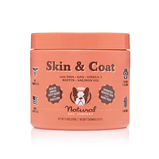The Skin & Coat Supplement for Dogs by Natural Dog Company, in an orange container with a dog graphic, offers 90 soft chews with DHA, EPA, Omega-3, Biotin, and Salmon Oil to support your dogs skin and coat health.