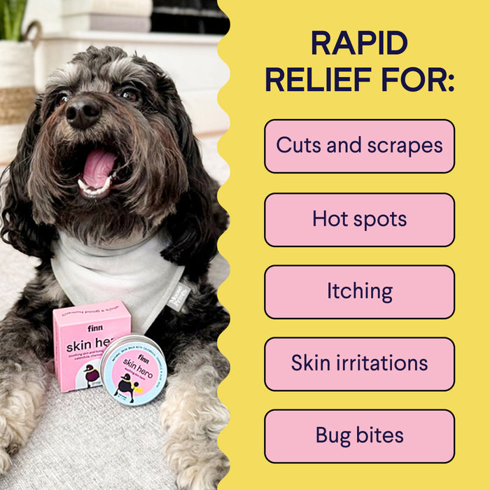 A happy black and gray dog wearing a light-colored bandana sits next to a box and a small container labeled "Finn Skin Hero." The image highlights the product's benefits for rapid relief from cuts and scrapes, hot spots, itching, skin irritations, and bug bites.