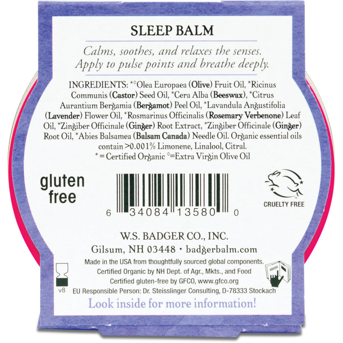 The image shows the back of a Badger Balm Sleep Balm container, highlighting ingredients such as olive oil, beeswax, and lavender. This natural sleep aid is gluten-free and cruelty-free with essential oils. It includes a barcode and W.S. Badger Co.s contact details.