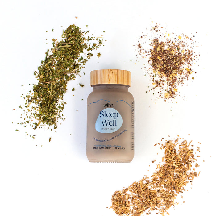 The Sleep Well bottle by WTHN, with its bamboo cap, is displayed among herbs and Organic Ashwagandha on a white background, creating an organic theme that promotes a naturally sedative atmosphere for deep sleep.