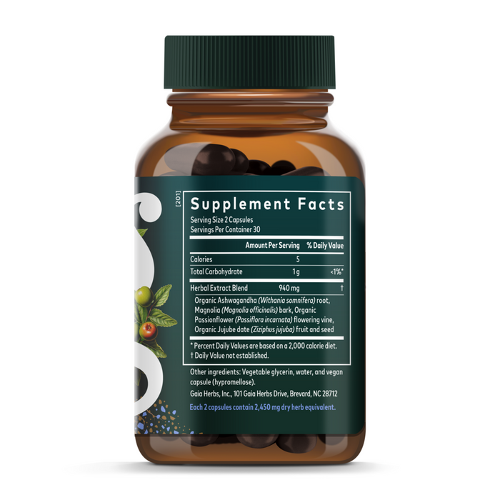 A brown Gaia Herbs SleepThru bottle with a green cap and label shows supplement facts, ingredients, and serving info. The dark capsules support sleep, and the label features ashwagandha plus images of leaves, berries, and fruit.
