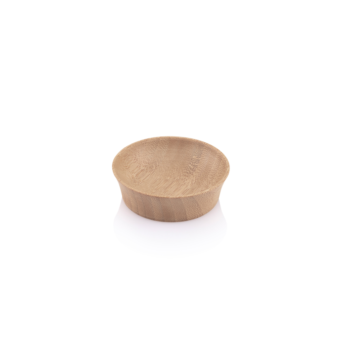 The Small Condiment Cup by Bambu is a small, round wooden bowl made from organic bamboo with a smooth surface. Set against a plain white background, it features a light, natural texture that exudes simplicity and eco-conscious elegance.