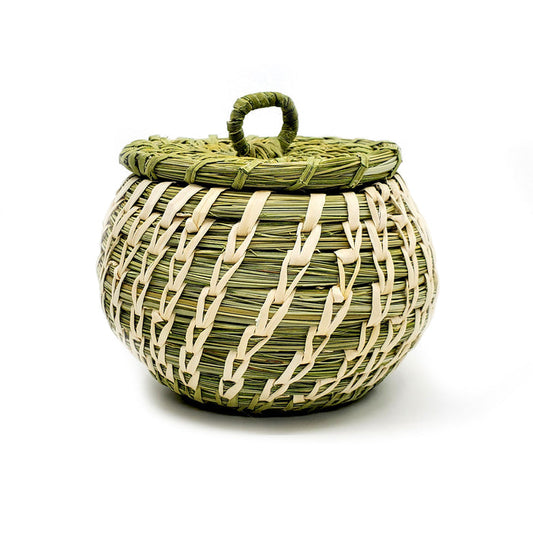 This handwoven basket is by Tohono O'Odham artist Fred Cruz from Sells, Arizona. Basket measures 3 inches tall plus 1 inch for the lid handle and 3.25 inches in diameter. Lid is removable for storage inside basket.  Plant materials are hand gathered from the Sonoran Desert. Green coils are native beargrass and the white, open stitches are of sun bleached yucca.