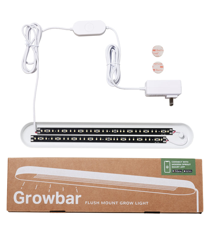 The Smart Growbar by Modern Sprout is an ideal LED grow light set for houseplants, featuring a full spectrum LED strip, power adapter, and adhesive mounts. It is displayed above a cardboard box labeled Smart Growbar.
