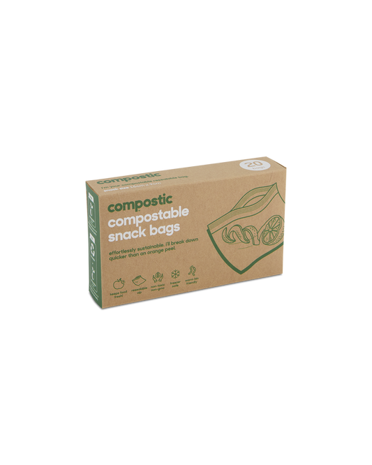 A box of Compostic Snack Bags contains 20 home-compostable bags made from renewable plant-based materials. The minimalist brown packaging is adorned with green text and fruit images, highlighting its eco-friendly nature.