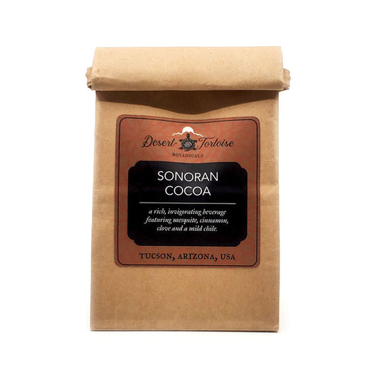 Sonoran Cocoa with Mesquite Meal &amp; Santa Cruz Mild Chile.&nbsp;
Made with local velvet mesquite meal, this traditional beverage (known as&nbsp;Champurro de Péchitas) is uniquely sweetened by the natural tang of velvet mesquite flour (wildharvested&nbsp;in Tucson, AZ).
The chile (locally grown in the Santa Cruz River Valley) is very mild with no heat, but adds a hint of flavor.&nbsp;

Ingredients: Cacao, Velvet Mesquite Flour, Santa Cruz Mild Chile, Cinnamon, Clove, Himalayan Pink Salt

Add 1 Tablespoon