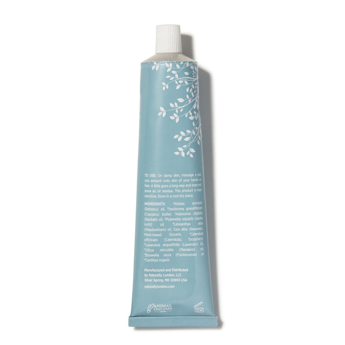 The Naturally London Soothing Balm for Feet & Hands comes in a blue tube with a white floral design and cap. Infused with Calendula and Baobab oil, it includes usage instructions, ingredients, and manufacturing details. The brand logo is at the bottom, perfect for soothing dry skin.