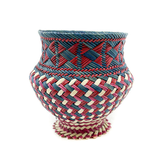 Woven vase with red, blue, and beige pattern on a white background