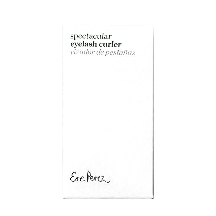 A white box showcases Spectacular Eyelash Curler and Rizador de Pestañas, highlighting hypoallergenic silicone pads. The brand Ere Perez elegantly features at the bottom in cursive for a natural curl experience.