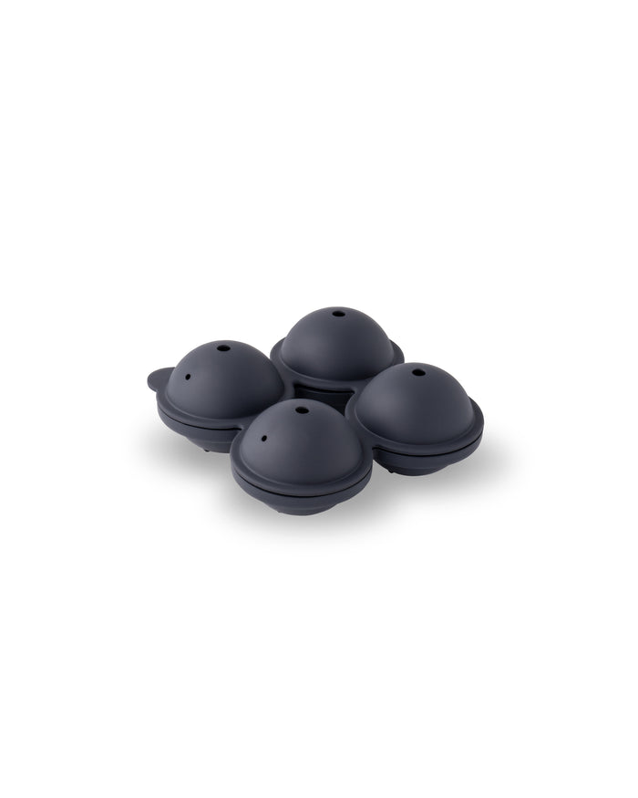 A Sphere Ice Tray by W&P, featuring a black four-sphere mold with small holes on top for crafting seamless, slow-melting ice spheres, is set against a plain white background.