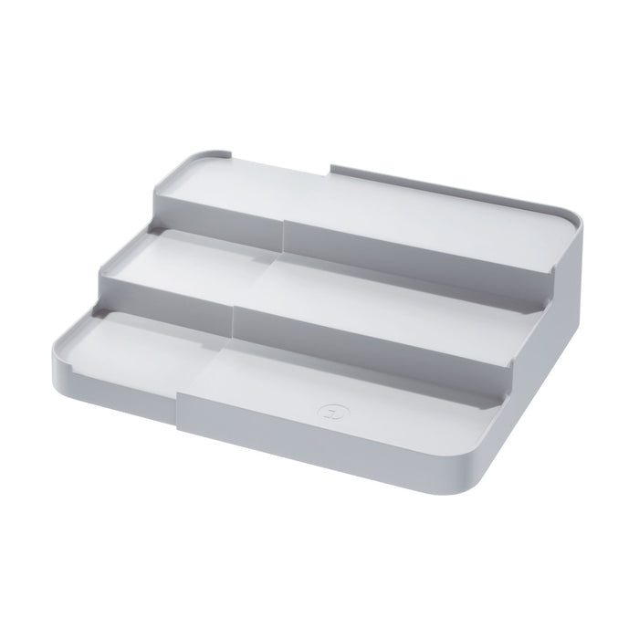 The iDesign Spice Rack Side Caddy is a three-tiered organizer tray made of recycled plastic, featuring a smooth gray surface with rounded edges. Each tier is slightly elevated, making it perfect for eco-friendly spice storage or office organization.