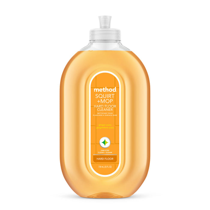 A bottle of methods Squirt & Mop Hard Floor Cleaner, certified by Leaping Bunny for no-wax floors, comes in a Ginger Yuzu scent. It features an oval-shaped bottle with orange liquid and a clear cap; the label highlights its purpose for cleaning hard floors.
