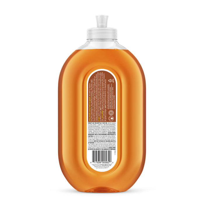 A clear plastic bottle of method Squirt + Mop Wood Floor Cleaner (VIP Discount) with orange liquid and a white flip-top cap is shown from the back, displaying a brown and white label with product info and barcode.