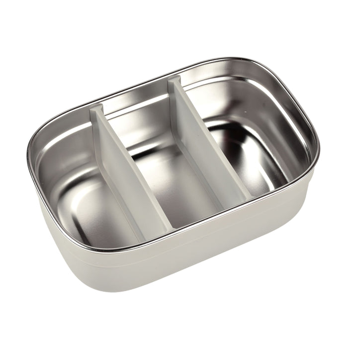 The BEABA Stainless Steel Bento Lunch Box boasts a shiny, metallic exterior with rounded edges. It includes two silicone dividers to easily form three sections. This eco-friendly container merges durability and style for your on-the-go meals.
