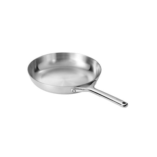 The Caraway Stainless Steel Fry Pan (10.5) with a long handle shines brilliantly on a light background. Its polished, non-toxic 5-ply steel surface is striking, and the cast shadow adds depth. This oven-safe pan seamlessly blends style and functionality.