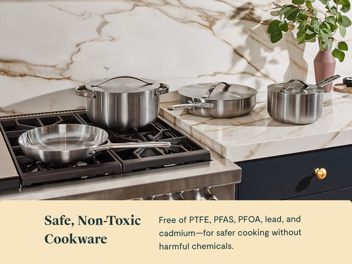 A Caraway Stainless Steel Fry Pan, 8", sits on a modern stovetop in a kitchen with marble counters. Text: Safe, non-toxic cookware—free of PTFE, PFAS, PFOA, lead, and cadmium for healthier cooking without harmful chemicals.