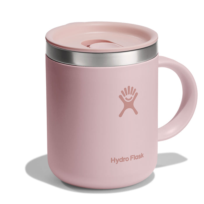 A 12 oz Hydro Flask Stainless Steel Mug in pink, with a handle and matching splash-resistant lid. It features the white Hydro Flask logo and a slightly raised lid that complements its design, casting a soft shadow.