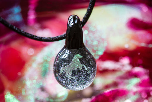 Teardrop glass pendant with holographic stallion inside and cremation ash on a black adjustable cord