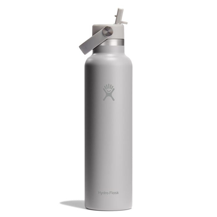 A 24 oz Hydro Flask Standard Mouth Bottle with Flex Straw Cap, featuring TempShield insulation and a flip-top spout. Its sleek, tall silver design is cupholder-compatible, with a small logo near the top and Hydro Flask near the base.