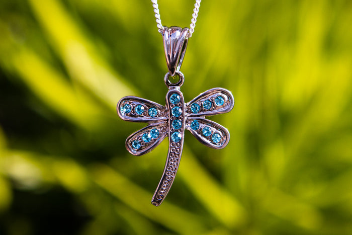 Sterling silver dragonfly pendant with blue crystals on a chain