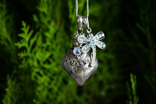 Sterling silver heart keepsake urn pendant with a jeweled dragonfly accent and chain.