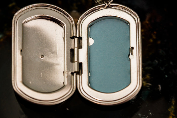 Open sterling silver star locket with blue interior panel