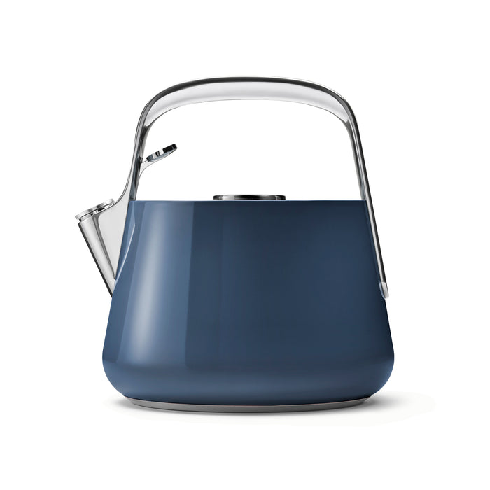 A dark blue Caraway Stovetop Whistling Tea Kettle, with a sleek silver handle, spout, and lid, is set against a white backdrop. Made from non-toxic materials, its minimalist design boasts glossy surfaces for a contemporary appearance.