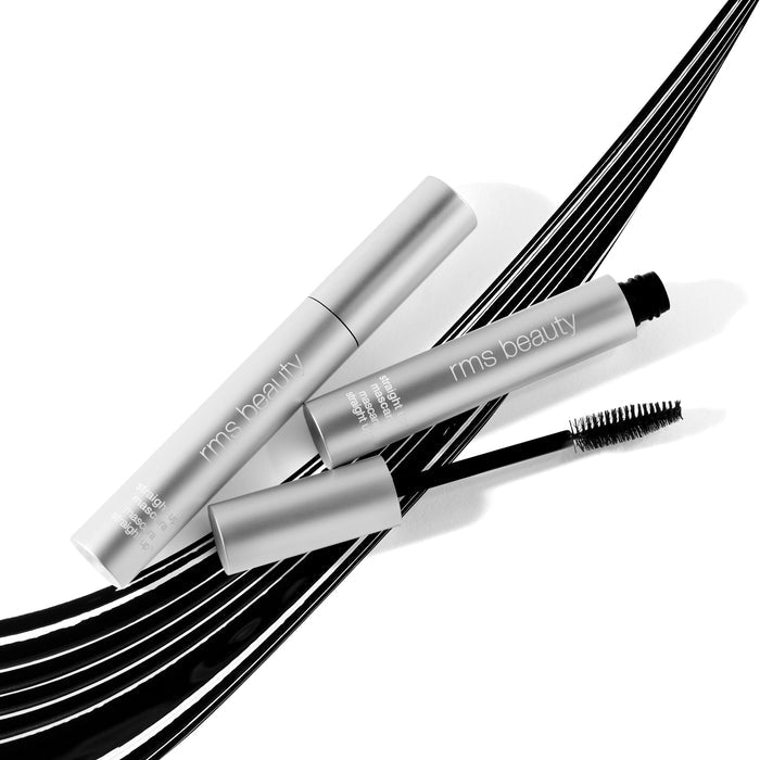 Two RMS Beauty Straight Up™ Volumizing Peptide Mascara tubes are on a white surface, with one open to show its black-bristled wand. Beneath them, stylish black strokes suggest the clean mascaras peptide-infused formula for enhanced volume.