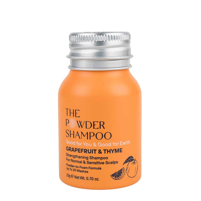 The Strengthening & Soothing Powder Shampoo by The Powder Shampoo, in its vibrant orange bottle with a metallic cap, features Grapefruit & Thyme for normal and sensitive scalps. Its powder-to-foam formula offers up to 20 washes, promoting eco-friendly benefits and scalp balance.