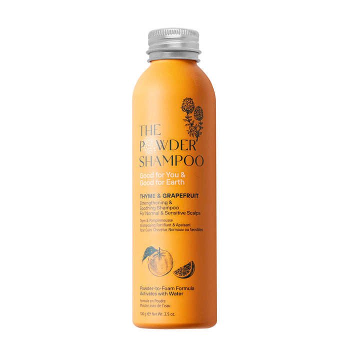 The Strengthening & Soothing Powder Shampoo by The Powder Shampoo comes in an orange bottle. Featuring thyme and grapefruit oil for normal/sensitive scalps, it showcases eco-friendly botanical designs and an innovative powder-to-foam formula.