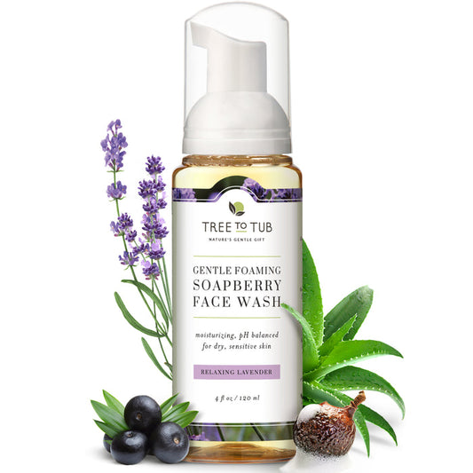 A bottle of Tree To Tub Sulfate Free Hydrating Face Wash for Dry Skin, with lavender, aloe vera, and soapberries around it, is displayed. Its label emphasizes the pH balance and hydrating formula suitable for sensitive or dry skin.