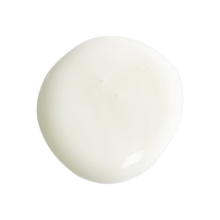 A small, round puddle of smooth, creamy white liquid on a plain white background reflects the glossy texture and luxury of Mad Hippies Super A Serum, crafted with Vitamin A for youthful skin and wrinkle reduction.