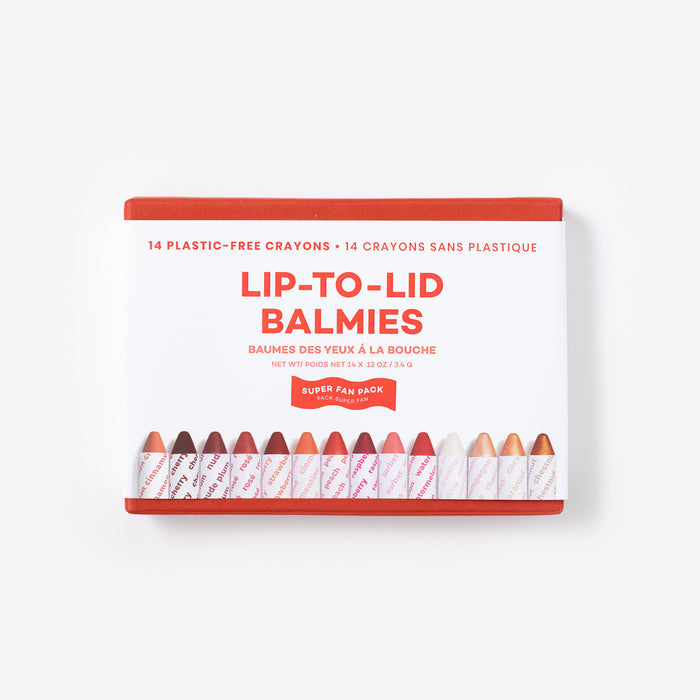 The Super Fan Pack by Axiology is a boxed set containing 14 multi-use crayons called Lip-to-Lid Balmies. These vegan cosmetics, displayed in various shades, come in packaging with a white background, red accents, and bilingual English and French text.