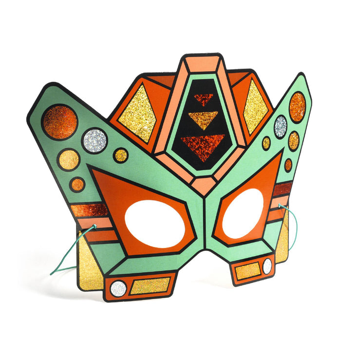 The DJECO Super Robots DIY Craft Kit features a geometric butterfly mask in orange, green, and gold with triangles, circles, and glitter. Part of the Super Robots collection, it includes eye holes and elastic strings for wearing or imaginative play. Made with FSC® Certified Paper.