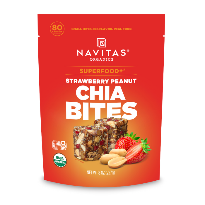 A red pouch of Navitas Organics Superfood+ Strawberry Peanut Chia BITES, featuring images of strawberry, peanut, and chia bites on the front, with product details and nutritional highlights for these superfood snacks.