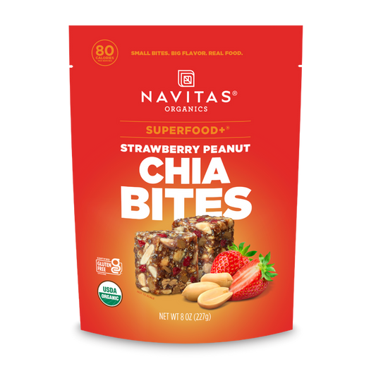 A red pouch of Navitas Organics Superfood+ Strawberry Peanut Chia BITES, featuring images of strawberry, peanut, and chia bites on the front, with product details and nutritional highlights for these superfood snacks.