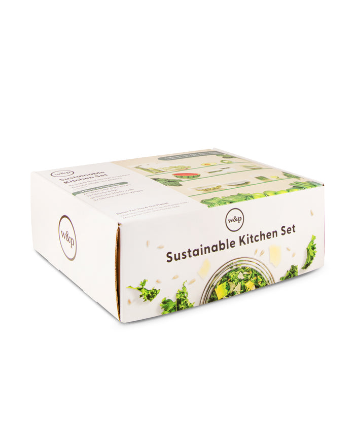 The Sustainable Kitchen Set box features green leaves and a salad bowl with greens, suggesting eco-friendly contents. It contains items like reusable stretch lids, all in a sleek white package with the W&P logo on the top left corner.