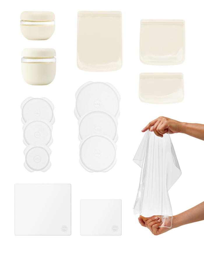 The W&P Sustainable Kitchen Set includes reusable storage essentials like round containers, rectangular pouches, and square covers. A stretchy transparent lid, showcased by hand, keeps food fresh. These white and clear items are designed for style and efficiency.