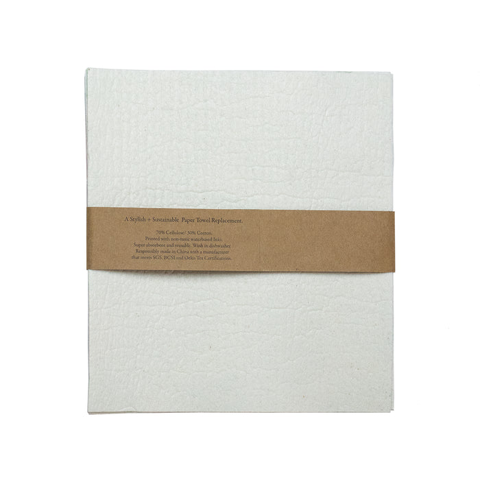 Supra Endura’s Swedish Dishcloths are stylish, sustainable white reusable cloths wrapped in a brown paper band reading A stylish + sustainable paper towel replacement, with washing instructions and environmental certifications provided.
