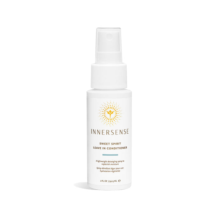 The Innersense Organic Beauty Sweet Spirit Leave-In Conditioner - Travel Size comes in a white spray bottle with a minimalist label and sunburst design. Enriched with aloe vera, this 2 fl oz (59.1 mL) detangler includes a clear cap for added convenience.
