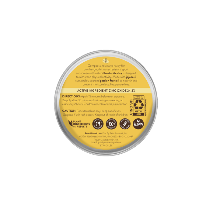 The Swim & Sport Mineral Balm - SPF 50 by Babo Botanicals is a round, beige container with a transparent lid, perfect for travel. It highlights an SPF 50 mineral sunscreen label with vegan and recyclable icons. Zinc oxide is the main ingredient; directions and caution are included, as well as company details in small text.