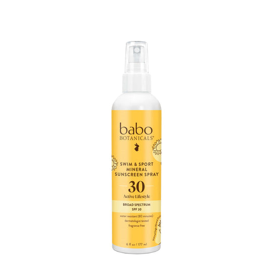 A 6 fl oz (177 ml) white and yellow bottle of Babo Botanicals Swim & Sport Mineral Spray SPF 30 features a non-greasy formula with broad-spectrum UVA/UVB protection, infused with sustainably sourced passion fruit seed oil.