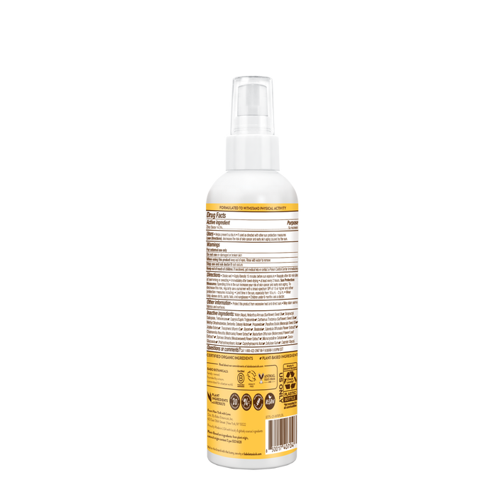 The rear view of a Babo Botanicals Swim & Sport Mineral Spray bottle reveals a white cap and yellow label with text and symbols for details and certifications. Set against a black background, this non-greasy spray features SPF 30 protection.