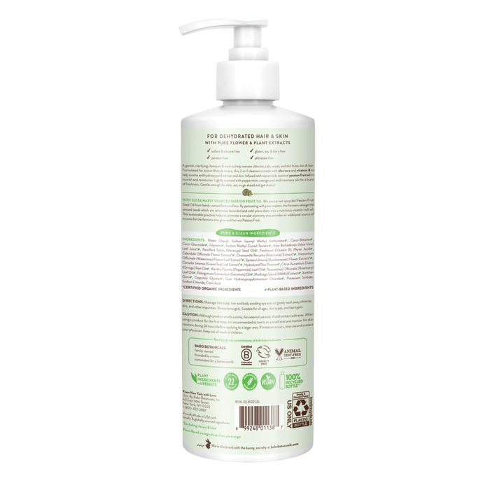 A white pump bottle of Babo Botanicals Swim & Sport Shampoo and Wash is displayed with its back label visible, detailing product information, directions, and ingredients—featuring passion fruit oil—as well as certifications and icons, all set against a light green background. Ideal for use as a clarifying shampoo or Swim & Sport Shampoo.
