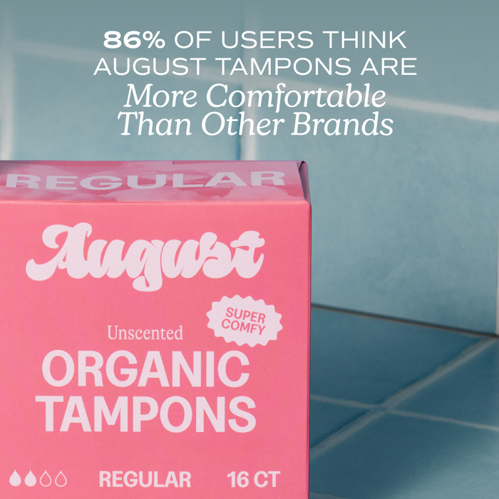 A pink box of August Regular Tampons sits on blue tiles. Above, text reads: 86% of users find August tampons more comfortable than other brands. The box highlights hypoallergenic tampons and a BPA-free applicator.